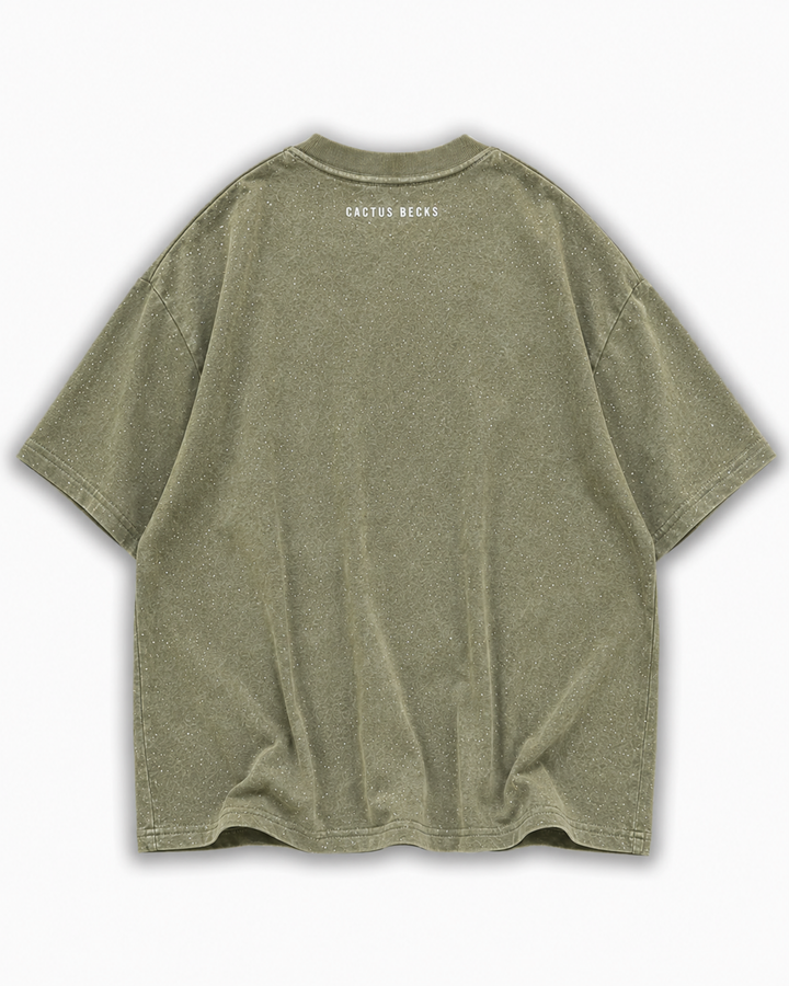 Green t-shirt with glitter dots and a small Cactus Becks logo on a white background