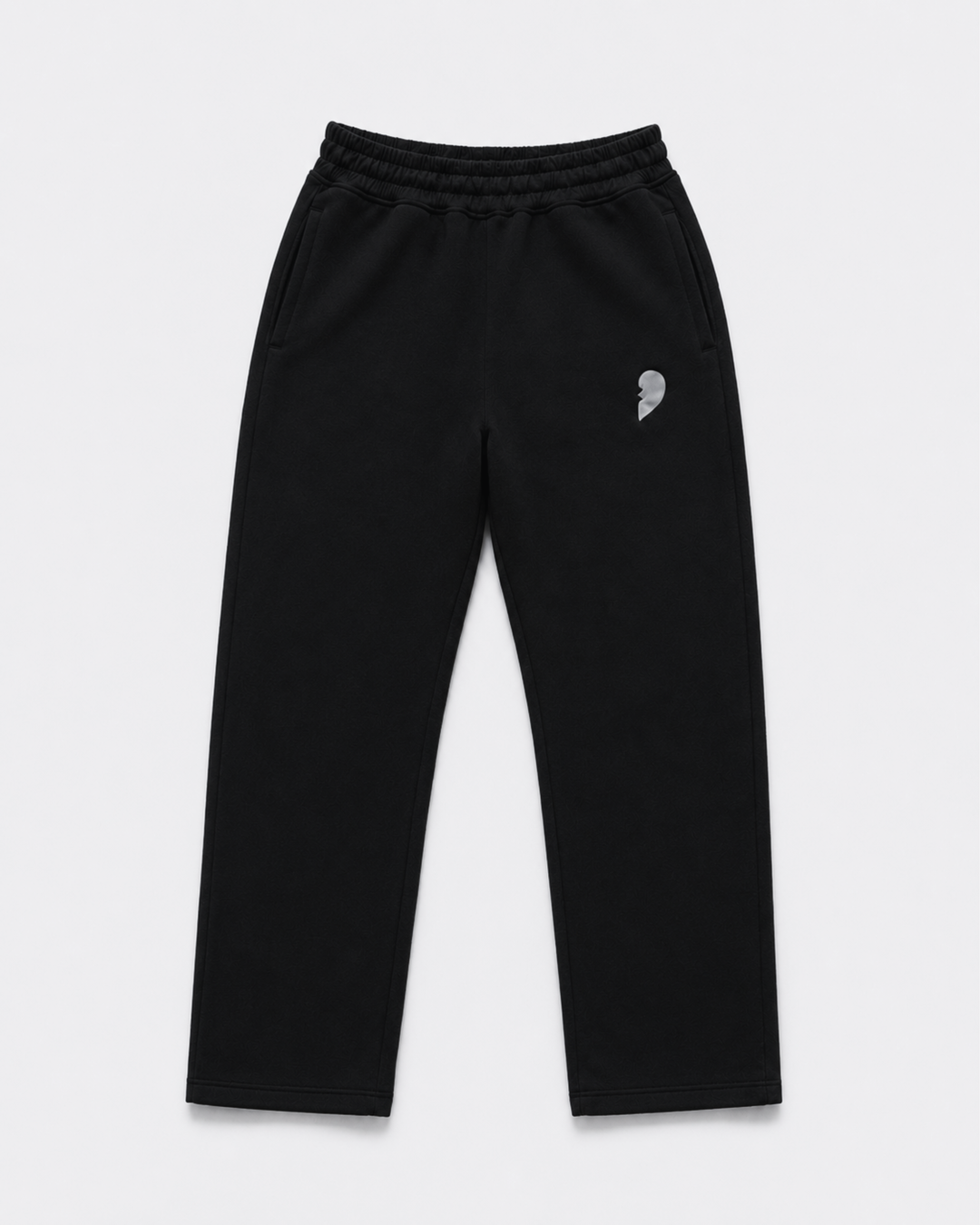 Black track pants with a broken heart on the front