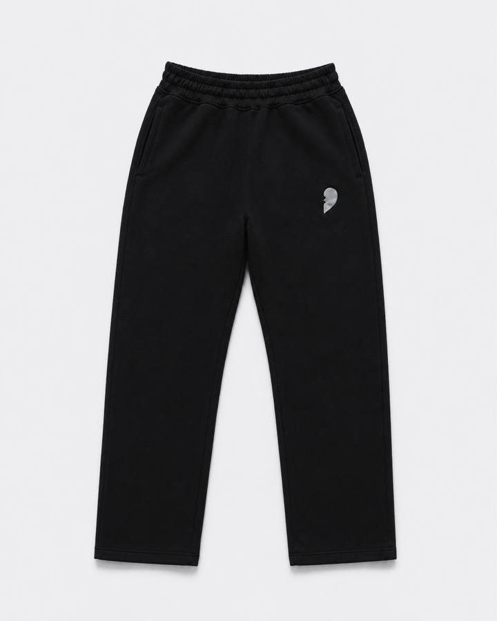 Black track pants with a broken heart on the front