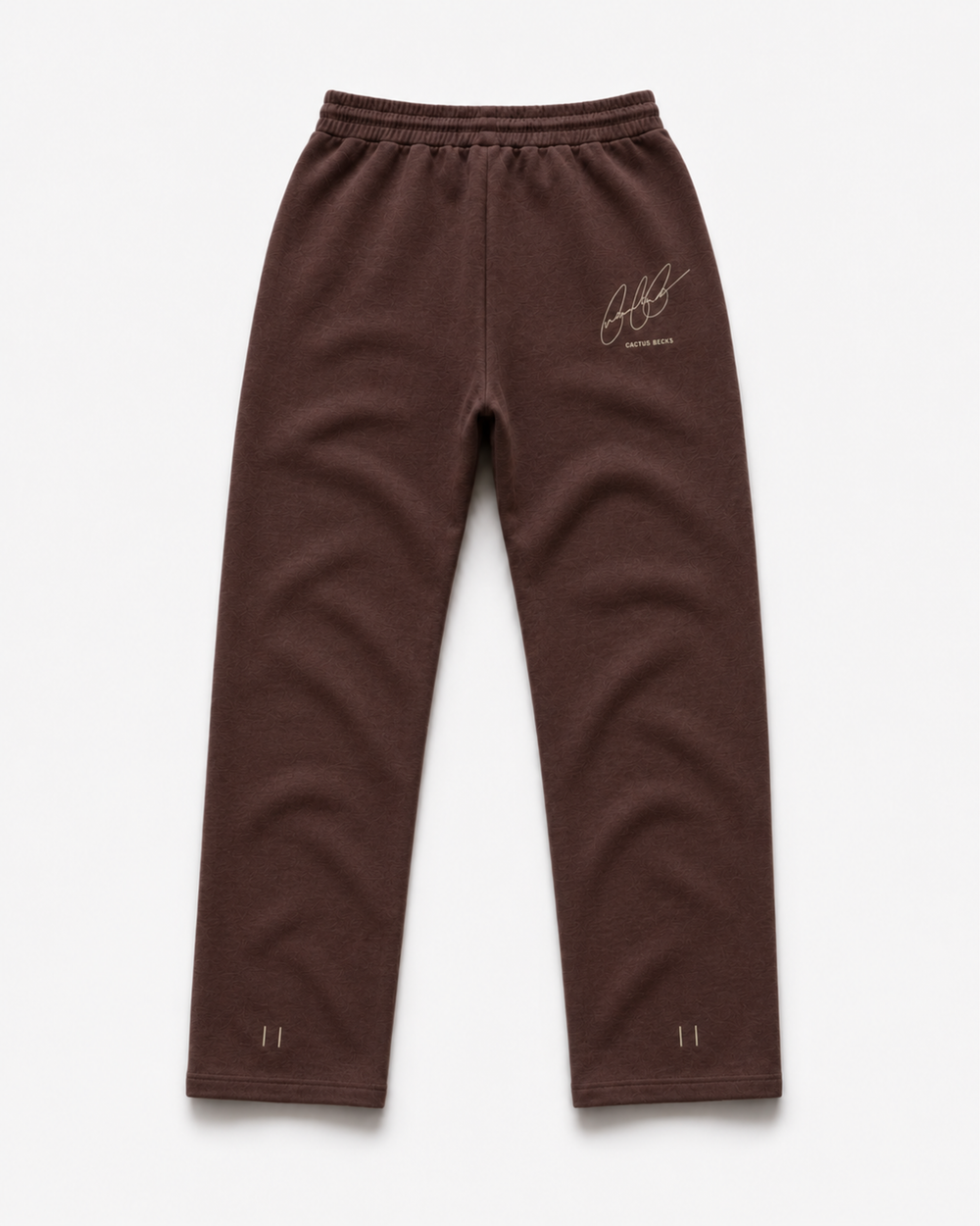 Brown track pants with Cactus Becks embroidery on the back and the 11/11 angel numbers.