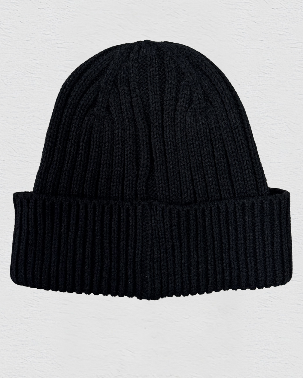 Black knit beanie on a light gray background