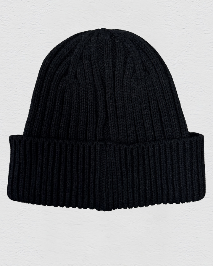 Black knit beanie on a light gray background