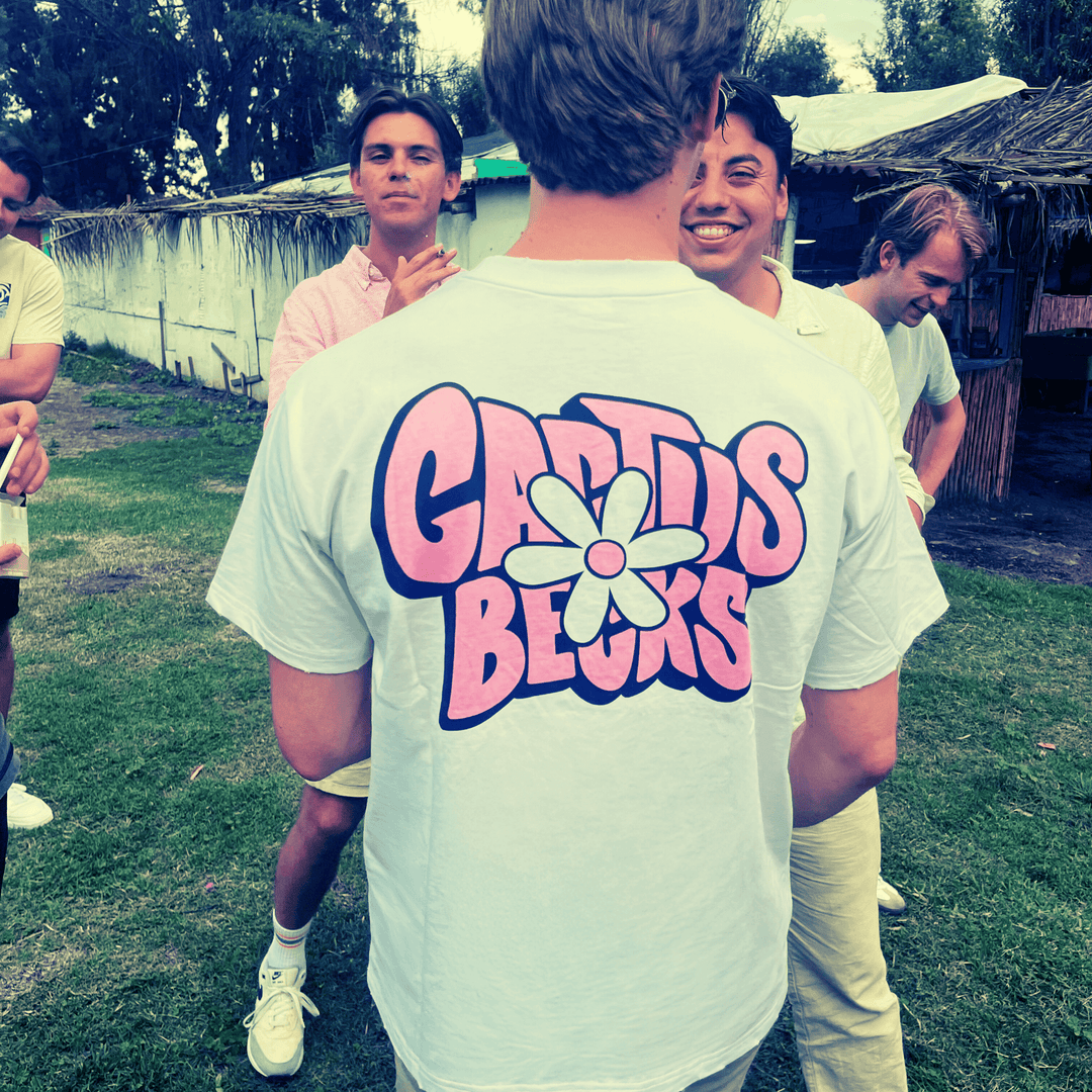 Group of friends outdoors wearing the Daisy Flower T-Shirt with distressed pink Cactus Becks and Daisy Flower design on the back