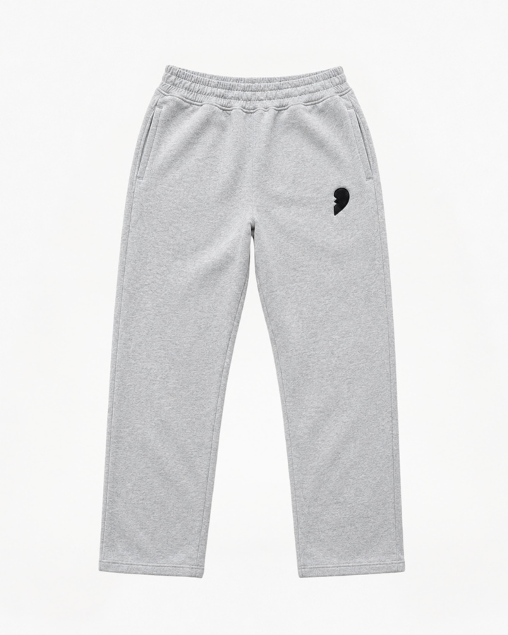 Gray track pants by cactus becks with a broken heart on the front