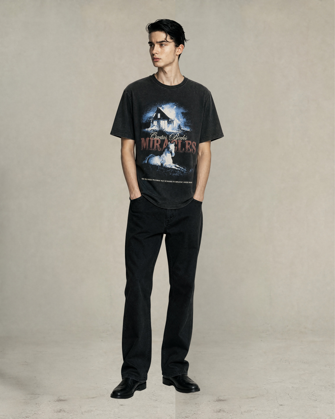 Male model wearing the Miracles T-Shirt by Cactus Becks with a black baggy jeans and smooth leather shoes