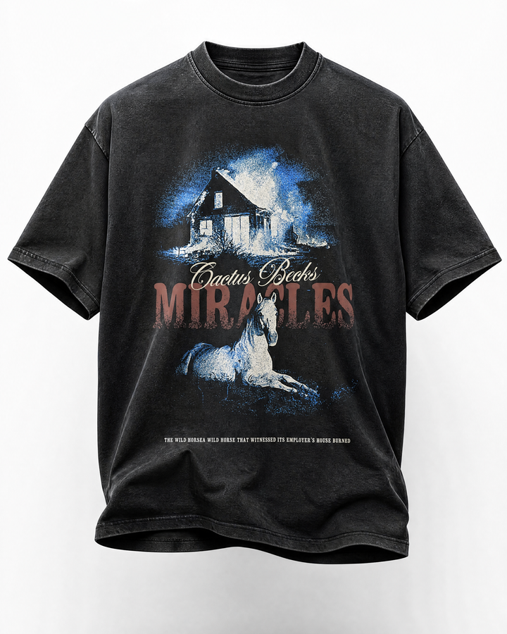 Black t-shirt with graphic design of a horse and burning house, featuring the text 'Cactus Becks Miracles'.