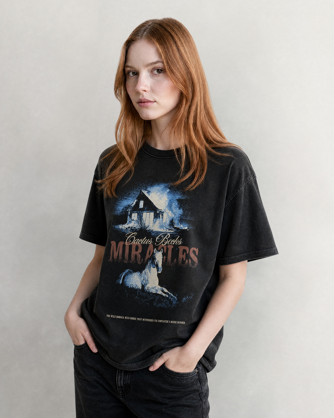 Female Model wearing the Miracles T-Shirt by Cactus Becks and a washed black jeans.